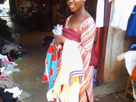Marie is in the market called Zairwa, where she's marketing and selling her tailoring products.